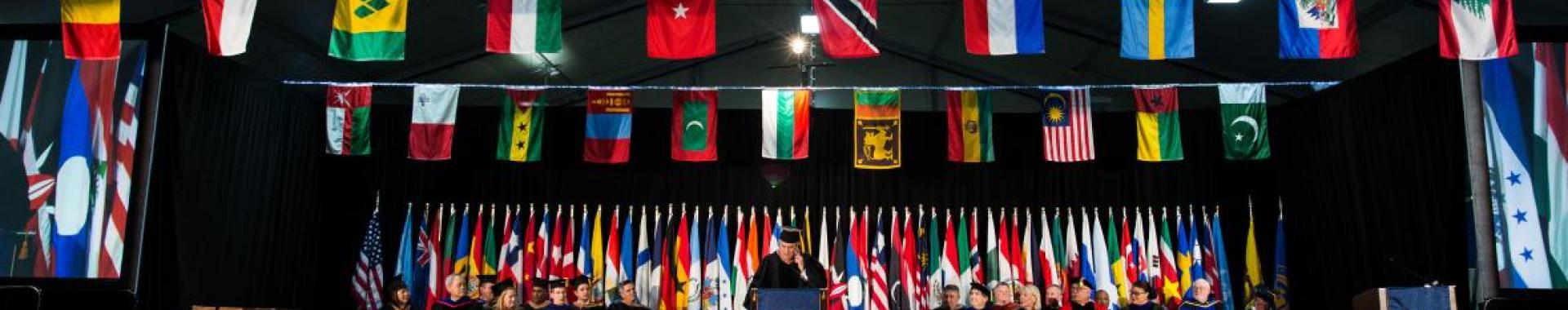 Thunderbird School of Global Management graduation ceremony with the world’s nations flags on display.